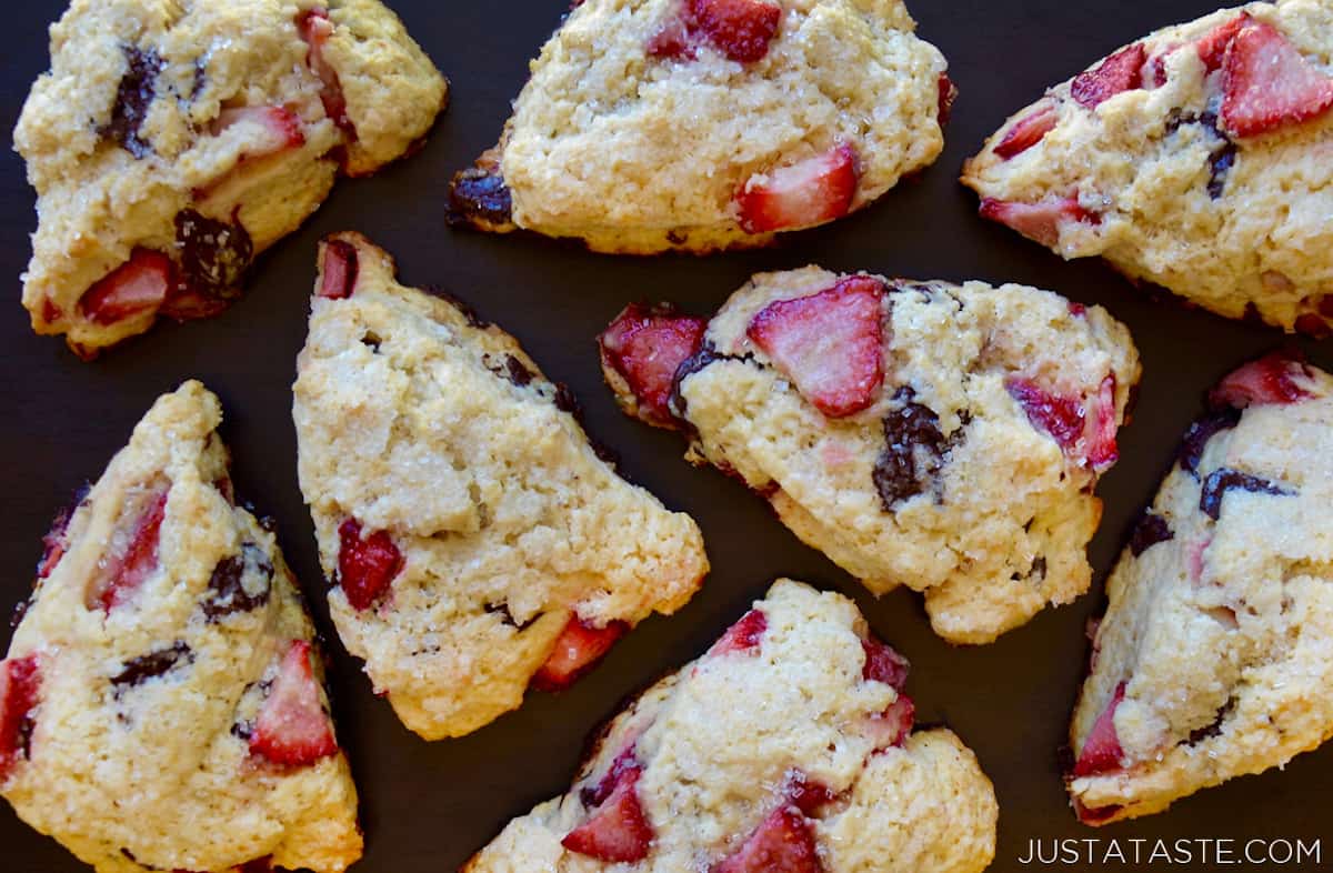 Eight wedges of strawberry chocolate scones topped with coarse sugar.