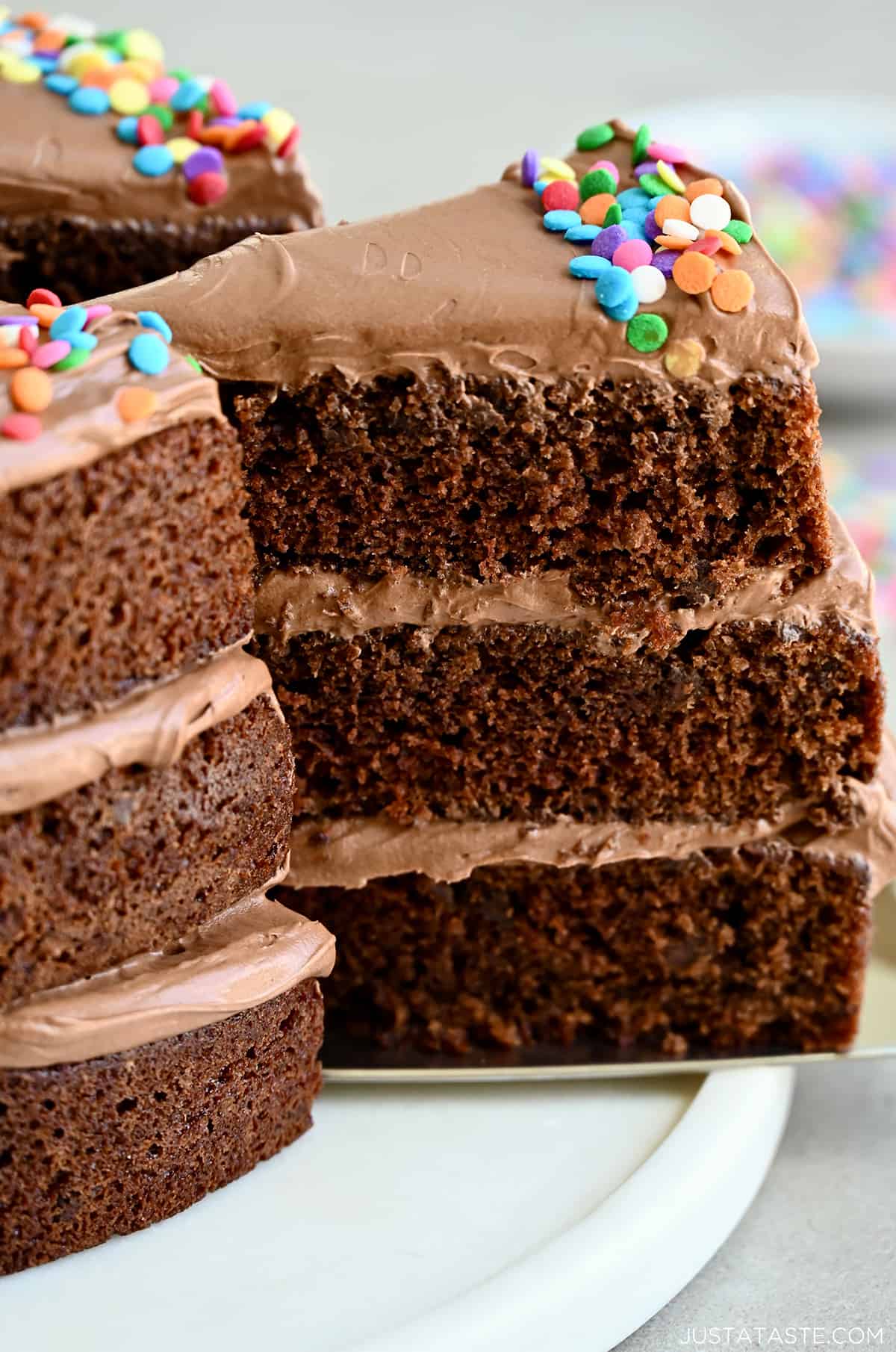 A slice of the best chocolate cake with three layers and coffee buttercream frosting. 
