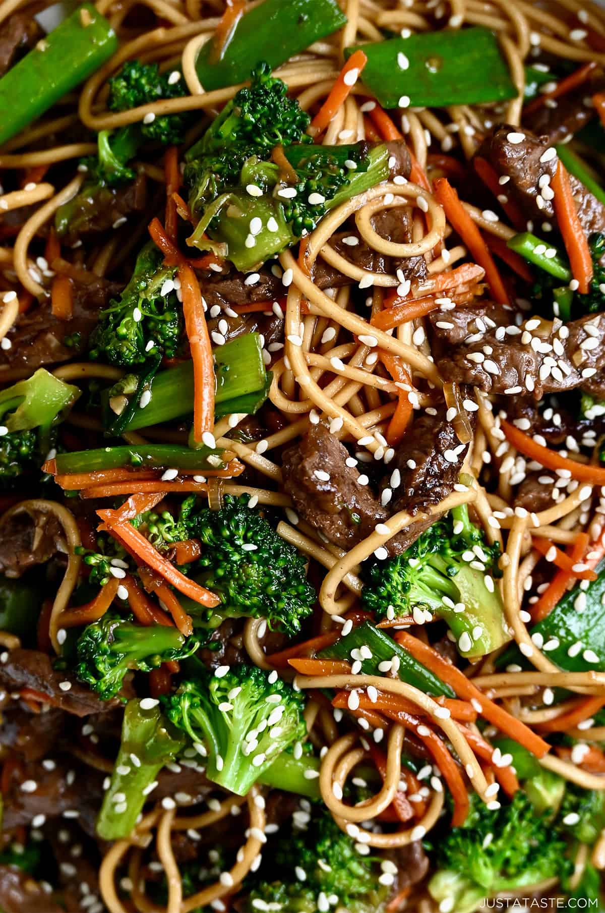 Beef lo mein with broccoli, carrots, scallions all tossed in a quick-fix sauce and garnished with sesame seeds.