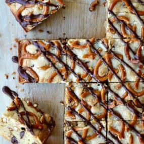 Pretzel chocolate chip cookie bars drizzled with melted chocolate and cut into squares.