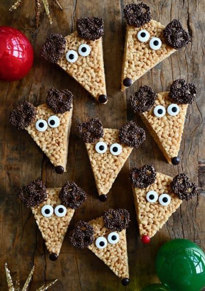 Triangles of Reindeer Rice Krispie Treats with chocolate-covered ears, candy eyes and M&M noses.