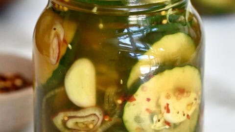 Homemade bread and butter pickles in a Mason jar.