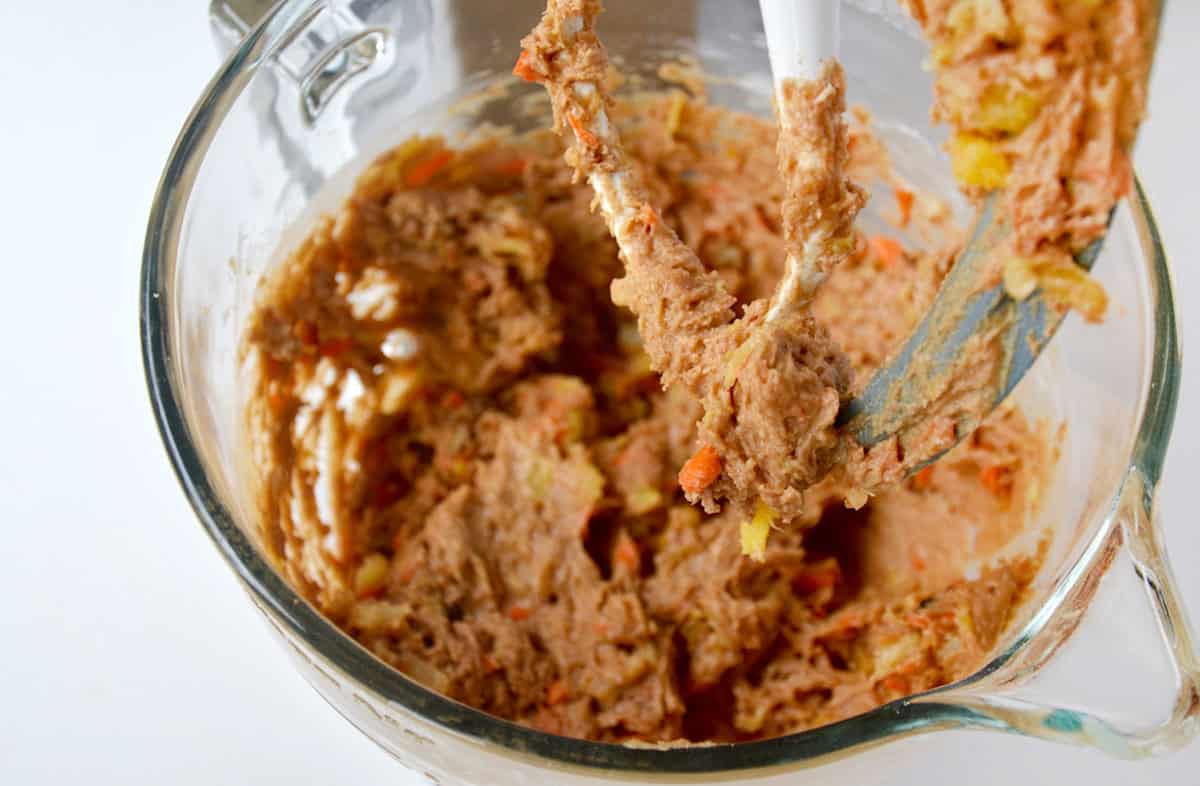 Carrot cake cookie batter in the bowl of stand mixer.