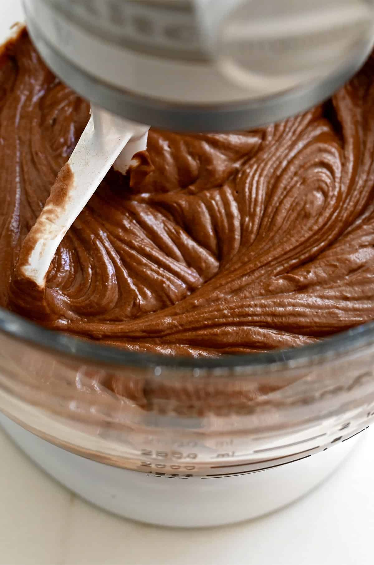 Chocolate cake batter in a stand mixer bowl with the paddle attachment.