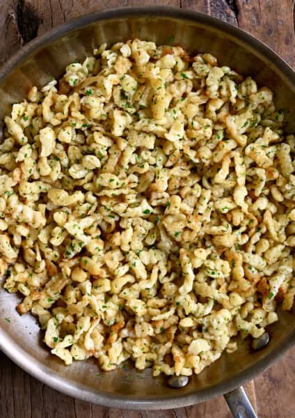 German spaetzle with butter and parsley in a large skillet.