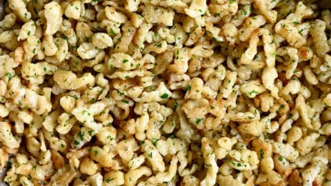 German spaetzle with butter and parsley in a large skillet.
