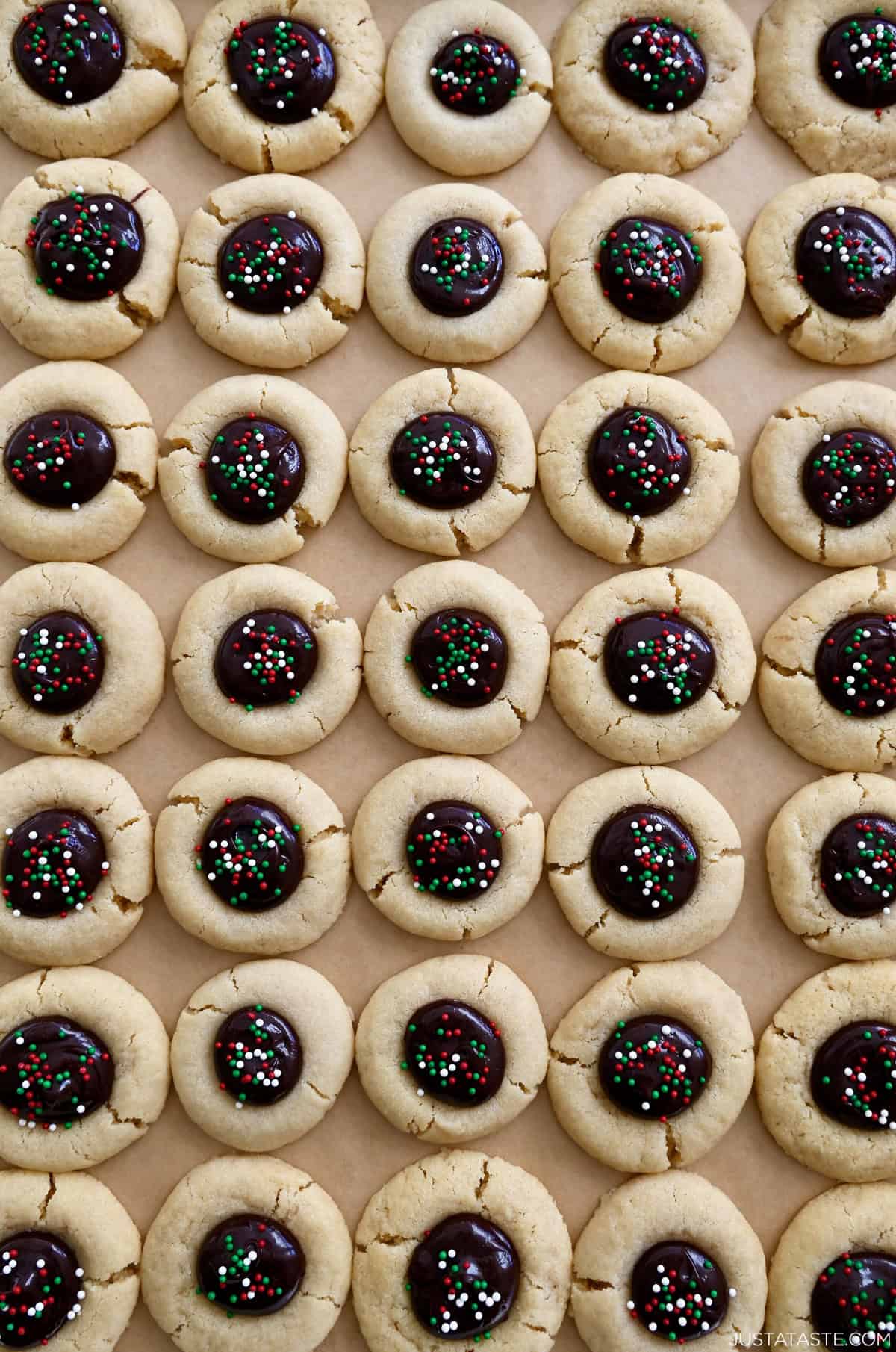 Christmas thumbprint cookies with festive sprinkles.