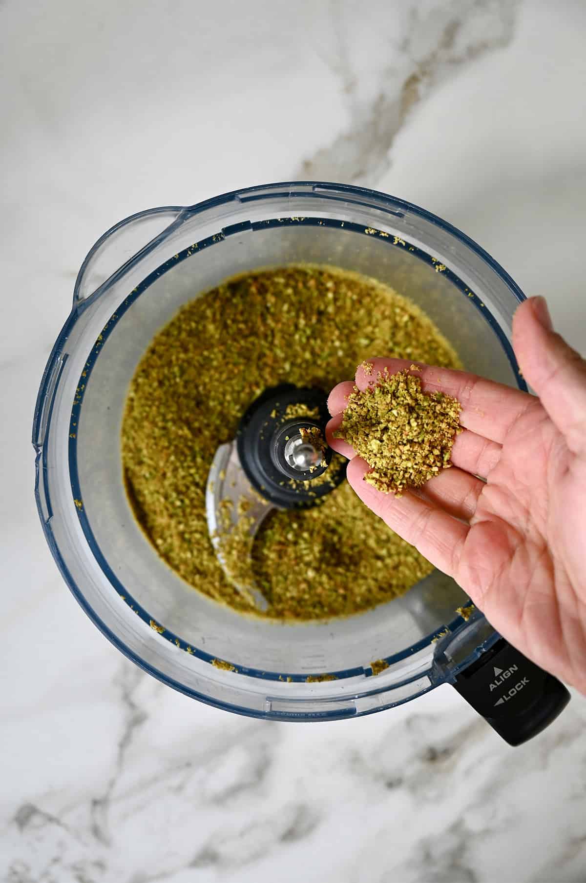 Finely ground pistachios in a food processor.