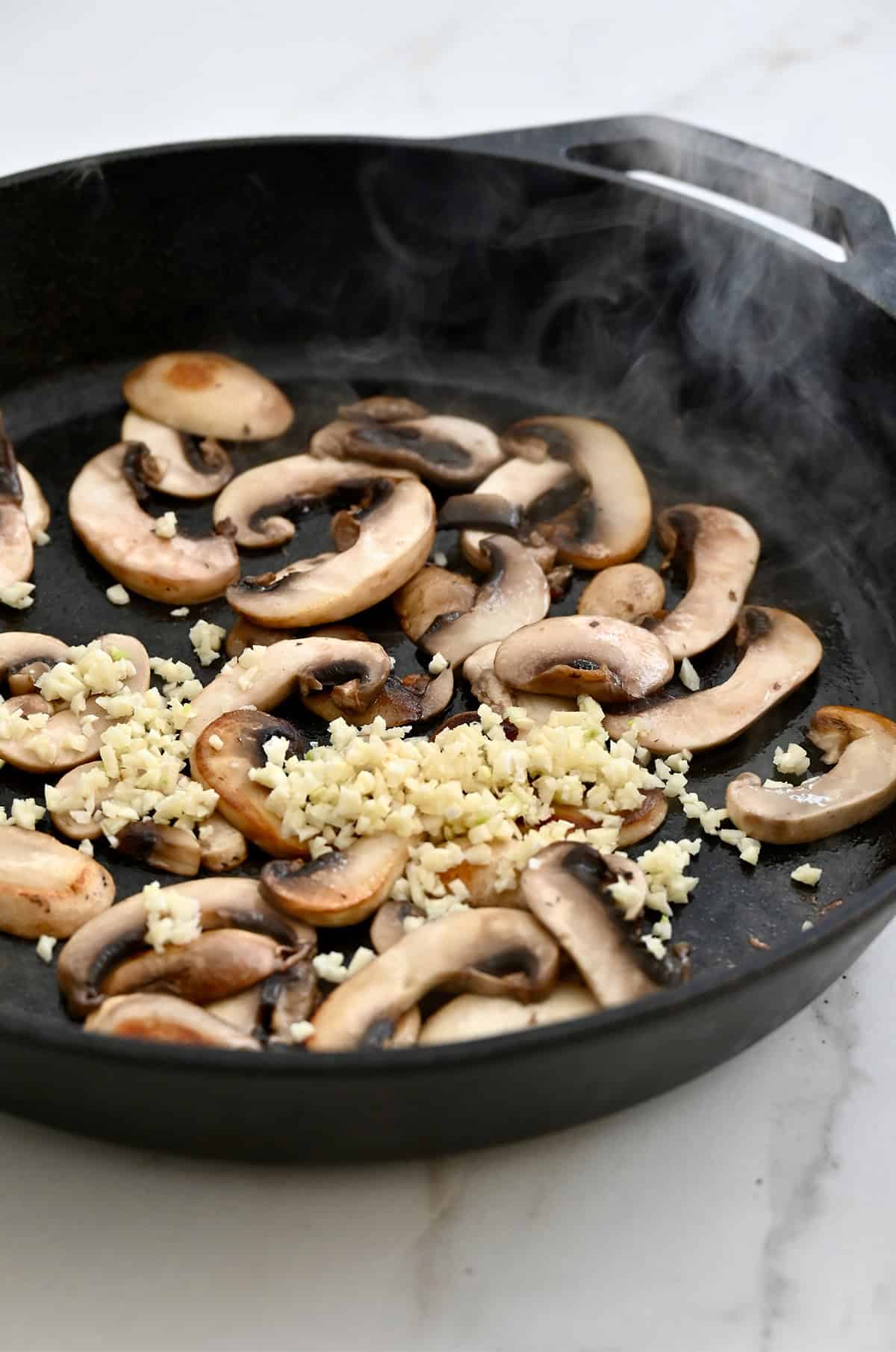 Sautéed mushrooms and garlic in a cast iron skillet.