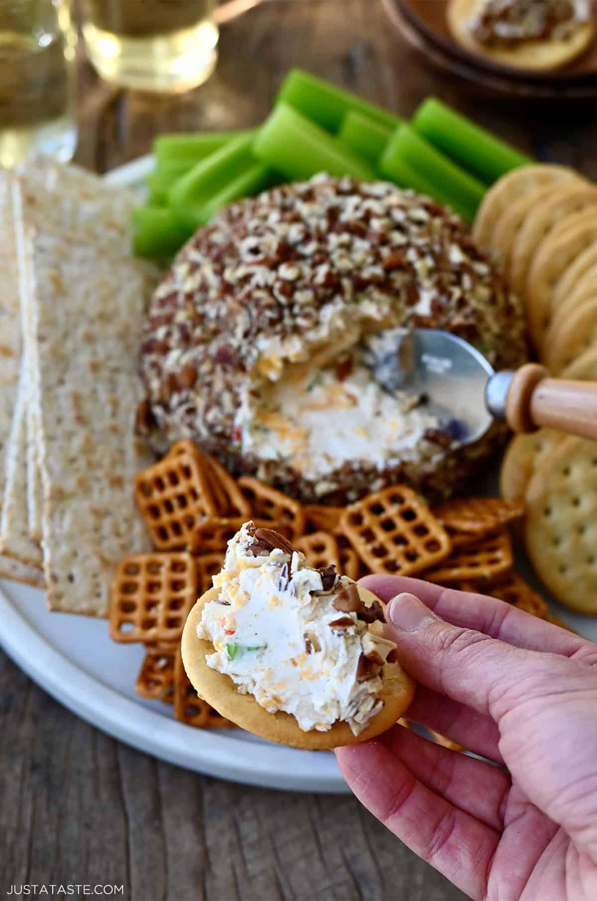 A scoop of cheese ball on a Ritz cracker.