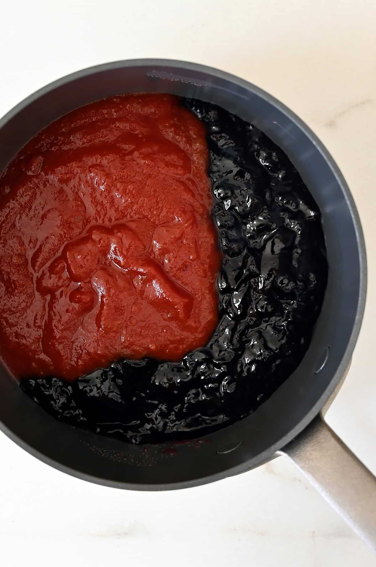 Grape jelly and chili sauce in a saucepan.