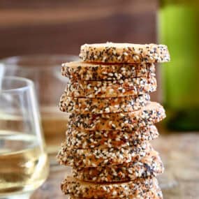 Savory shortbread cookies with everything bagel seasoning stacked 11 high.