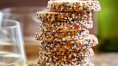 Savory shortbread cookies with everything bagel seasoning stacked 11 high.