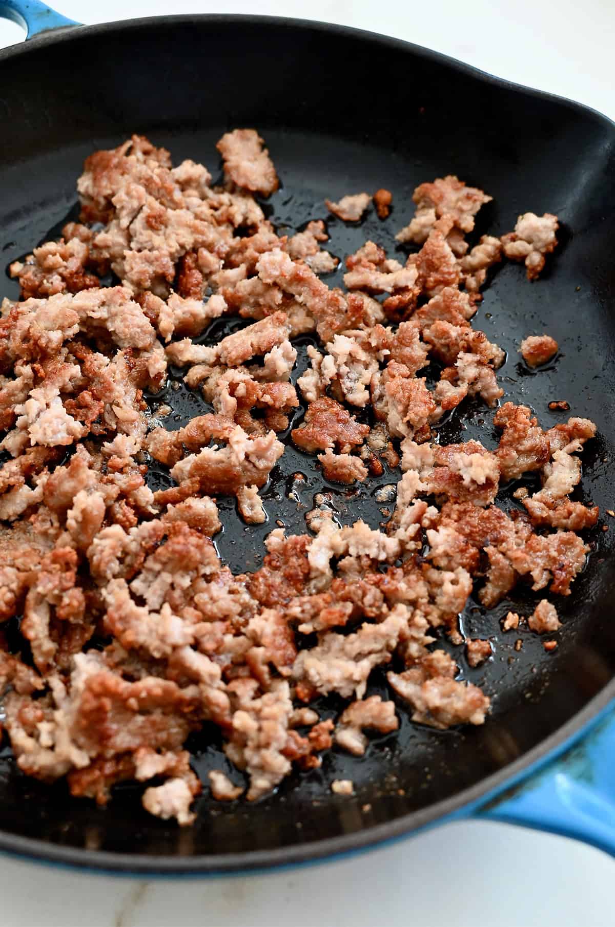 Browned breakfast sausage in a skillet.