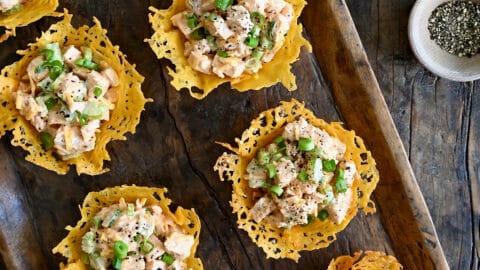 Buffalo chicken salad in individual cups made from melted cheese.