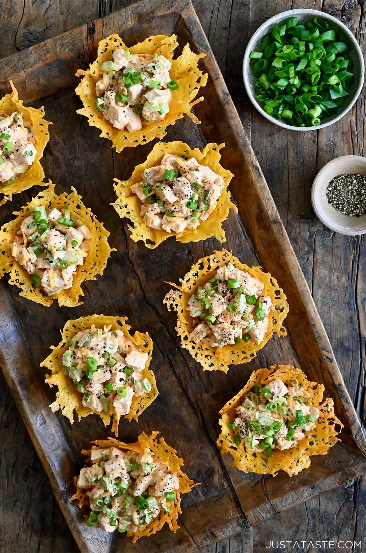 Buffalo chicken salad in individual cups made from melted cheese.