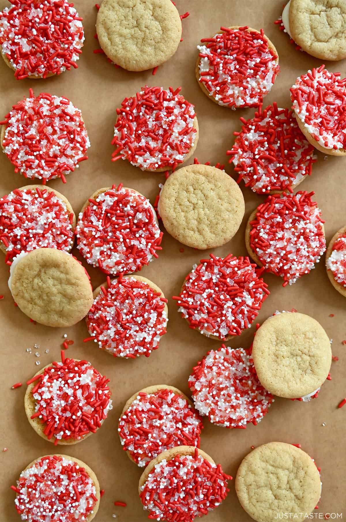 Chocolate chipless cookies dipped in white chocolate with red and white sprinkles.