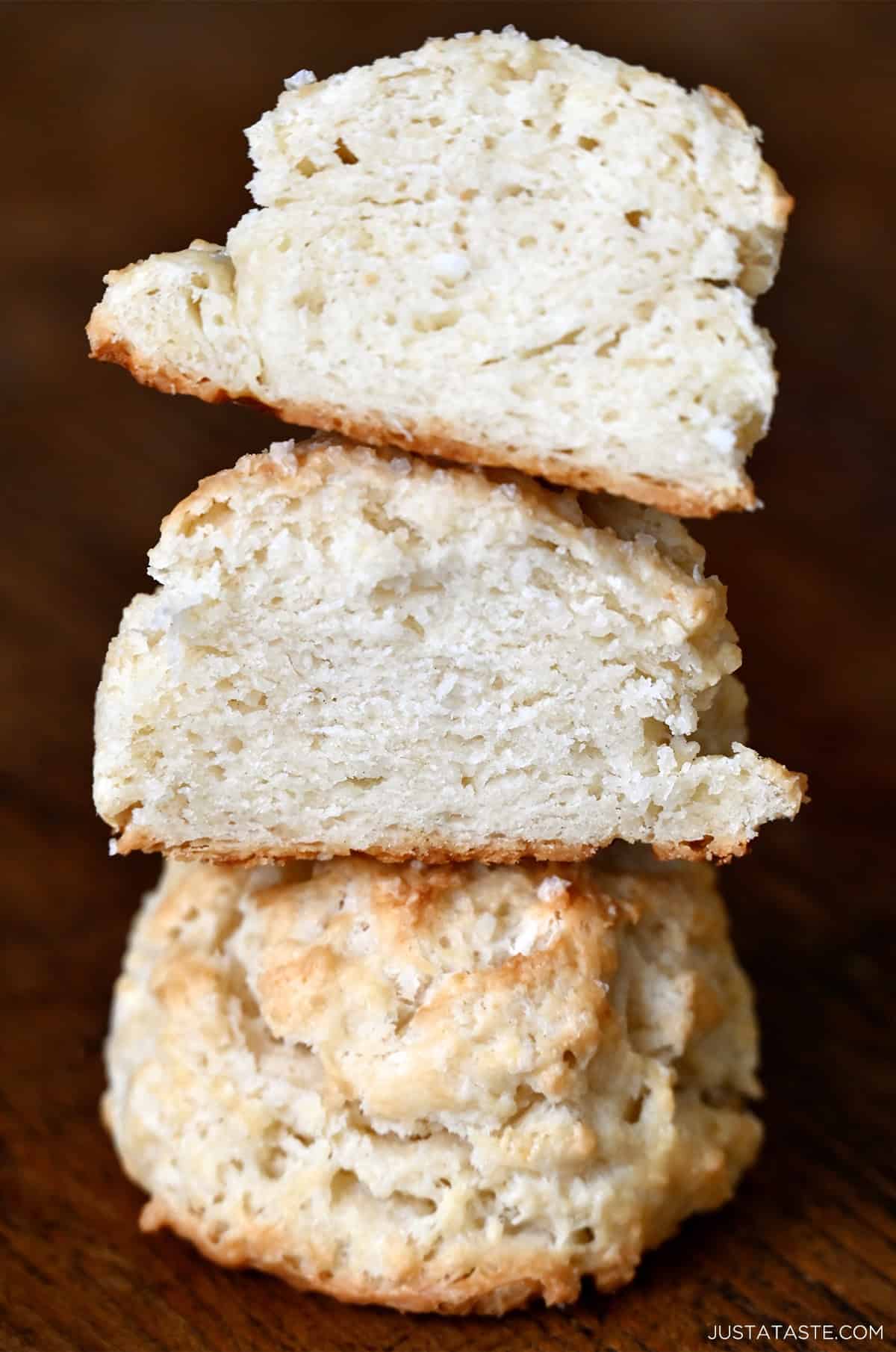 A tall and fluffy drop biscuit cut in half and piled atop another biscuit.
