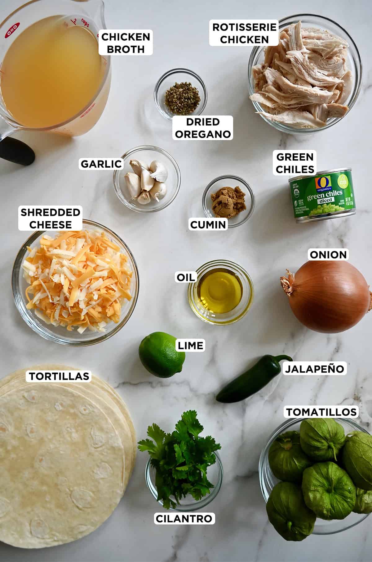All the ingredients needed to make green chili chicken enchiladas in glass bowls.
