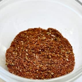Homemade taco seasoning in a glass bowl.
