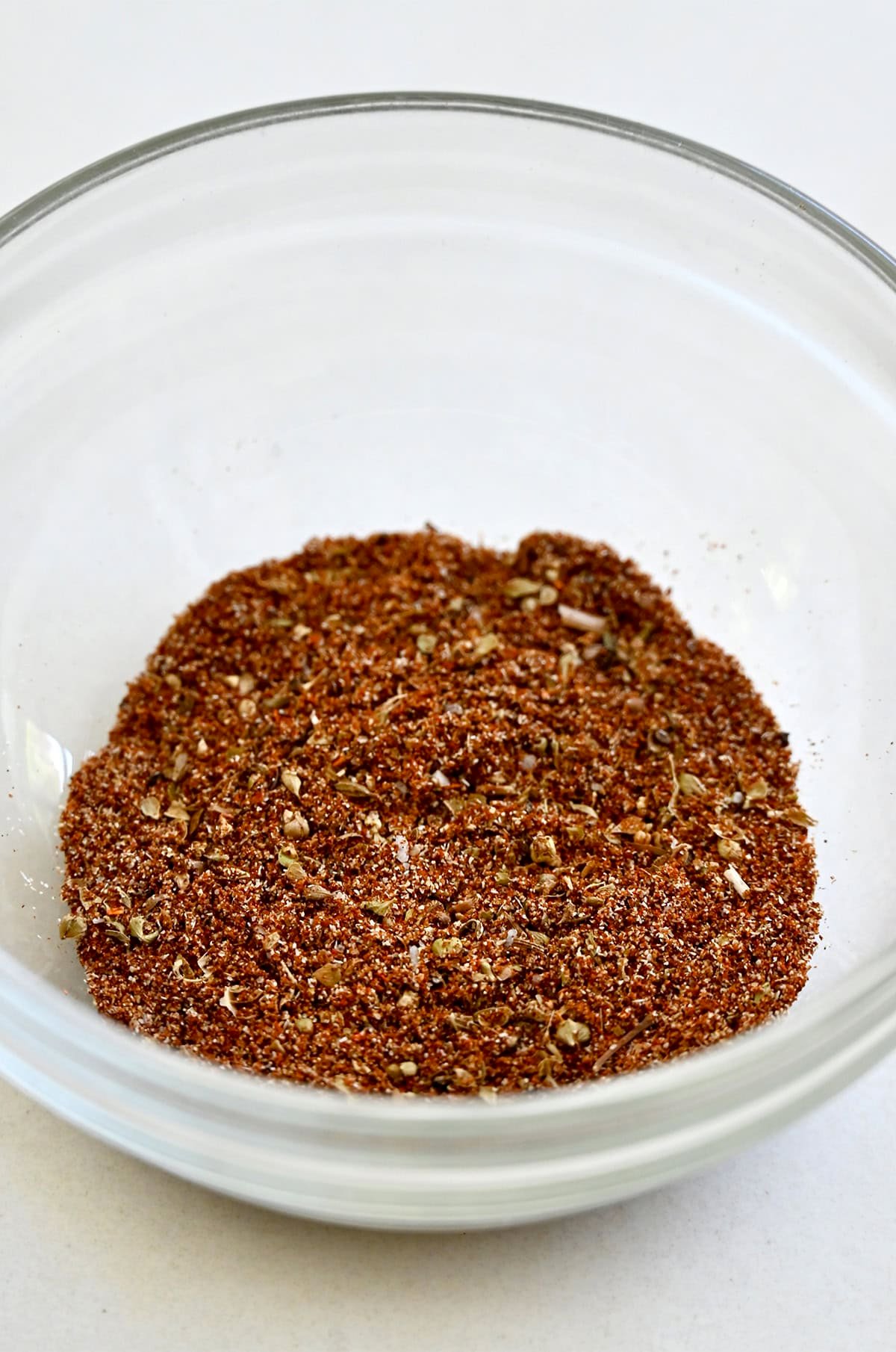 Homemade taco seasoning in a glass bowl.