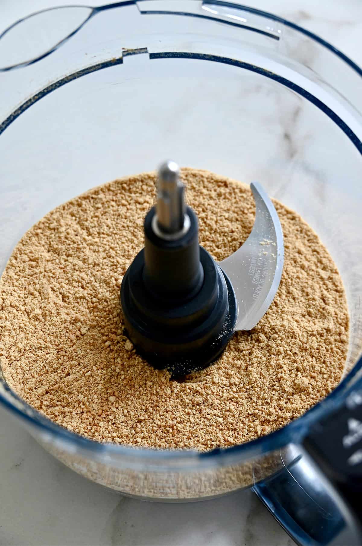 Finely crushed graham crackers in a food processor.