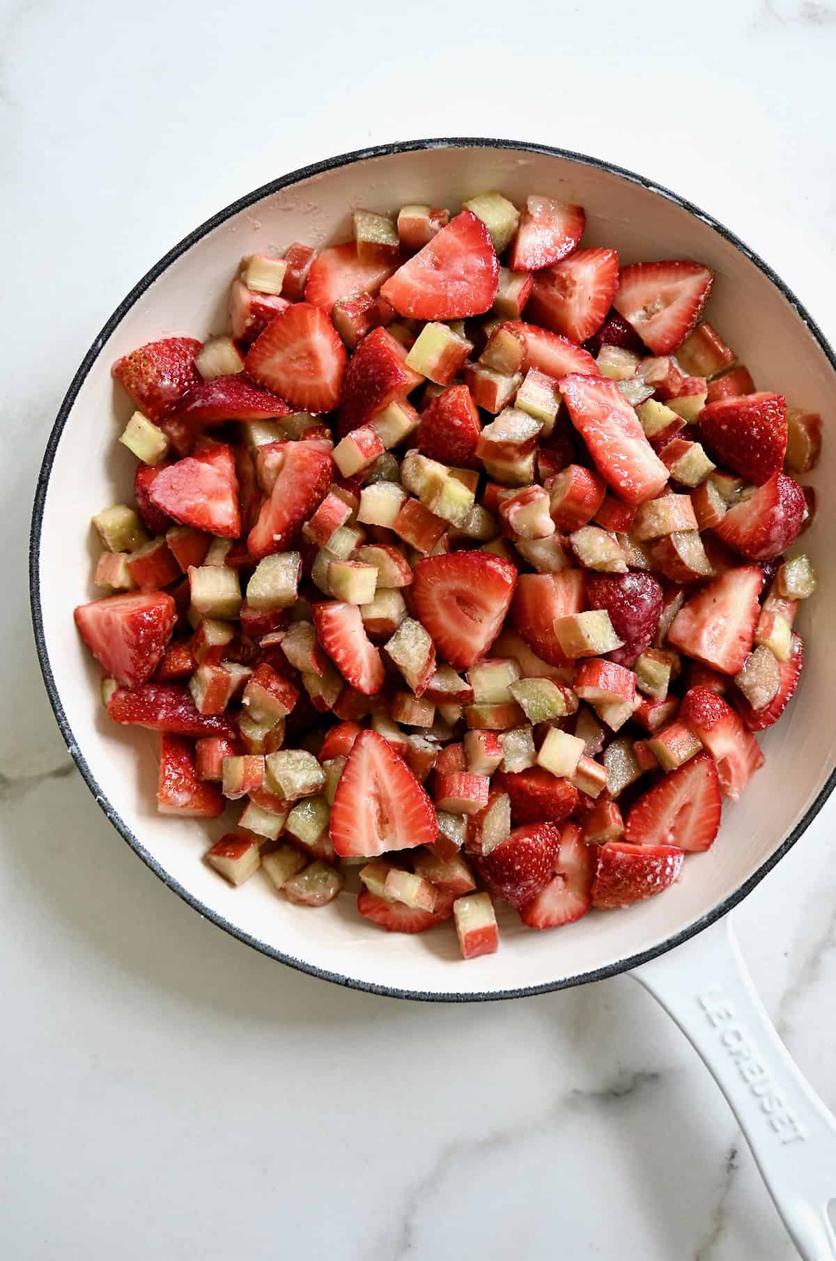 Strawberry rhubarb filling in a greased enameled skillet.