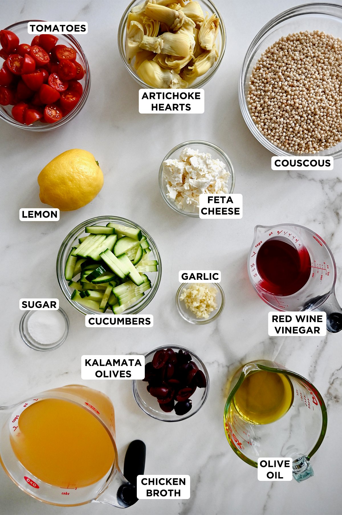 Ingredients to make Mediterranean couscous salad with a tangy red wine vinaigrette.