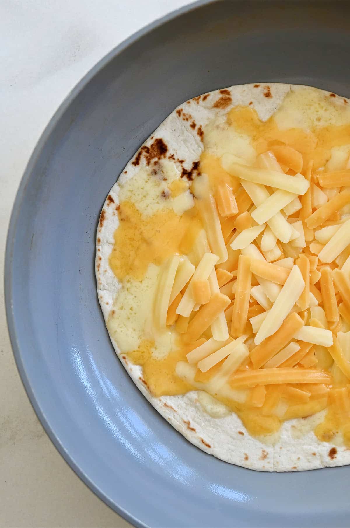 Making a cheese quesadilla.