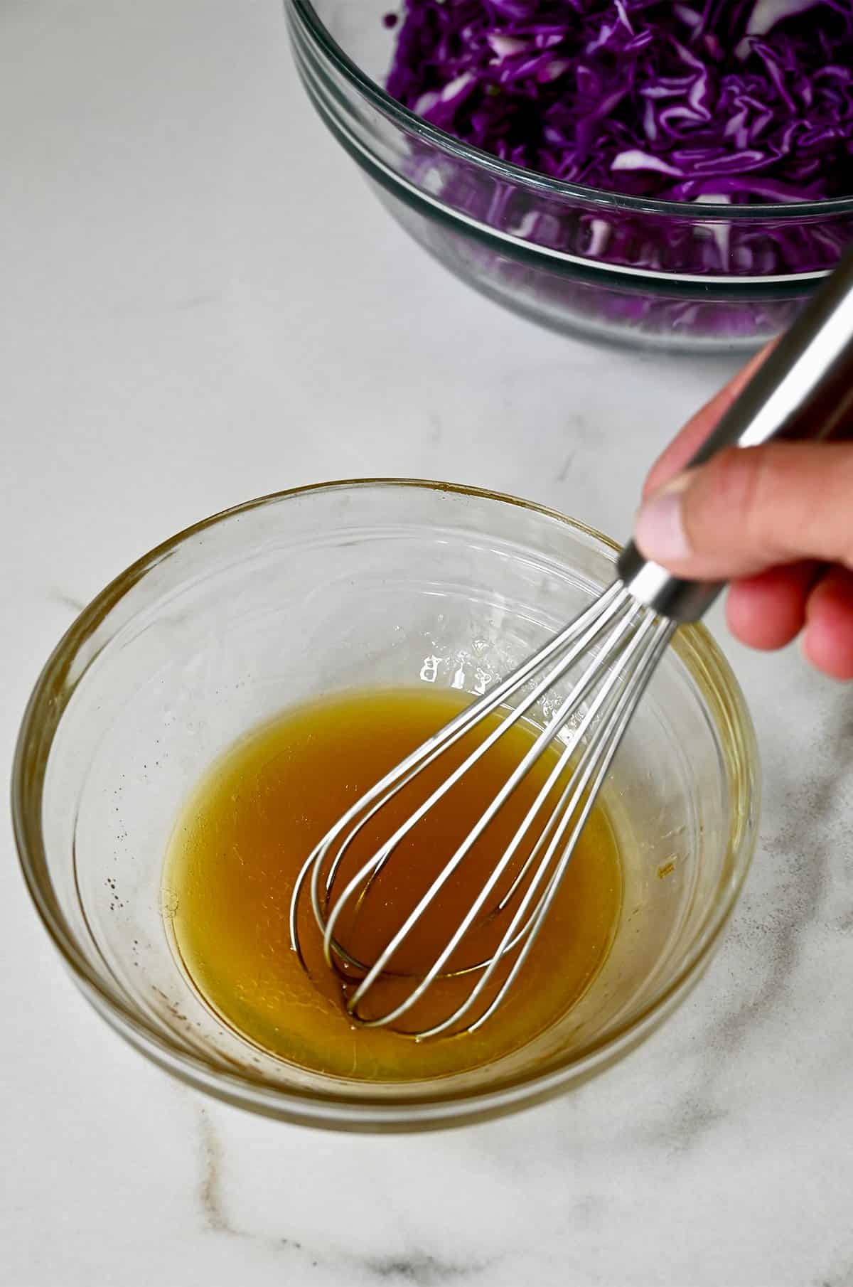 Sesame oil, fish sauce, olive oil, sugar and lime juice are whisked together in a small bowl to make a simple Asian dressing.
