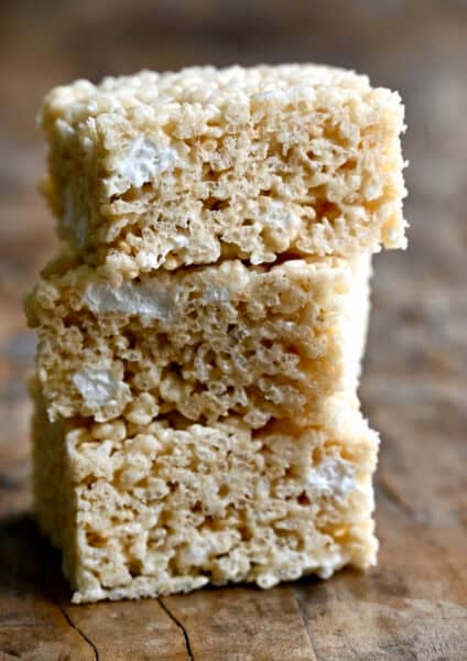 Three extra-gooey homemade Rice Krispie Treats piled atop each other.