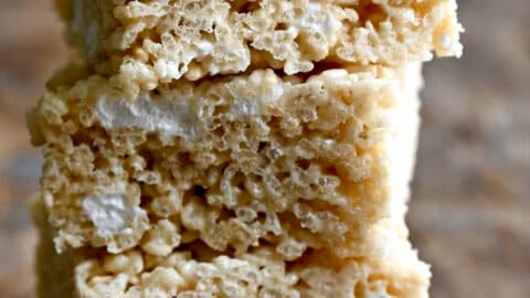 Three extra-gooey homemade Rice Krispie Treats piled atop each other.