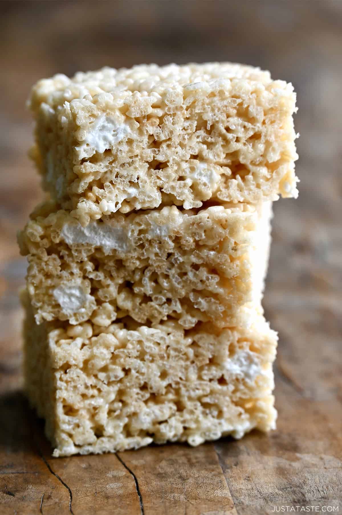 Three extra-gooey homemade Rice Krispie Treats piled atop each other.