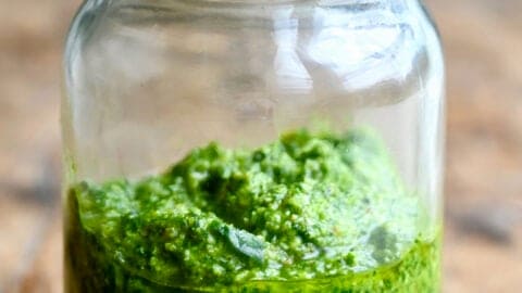 Homemade basil pesto in a mason jar.