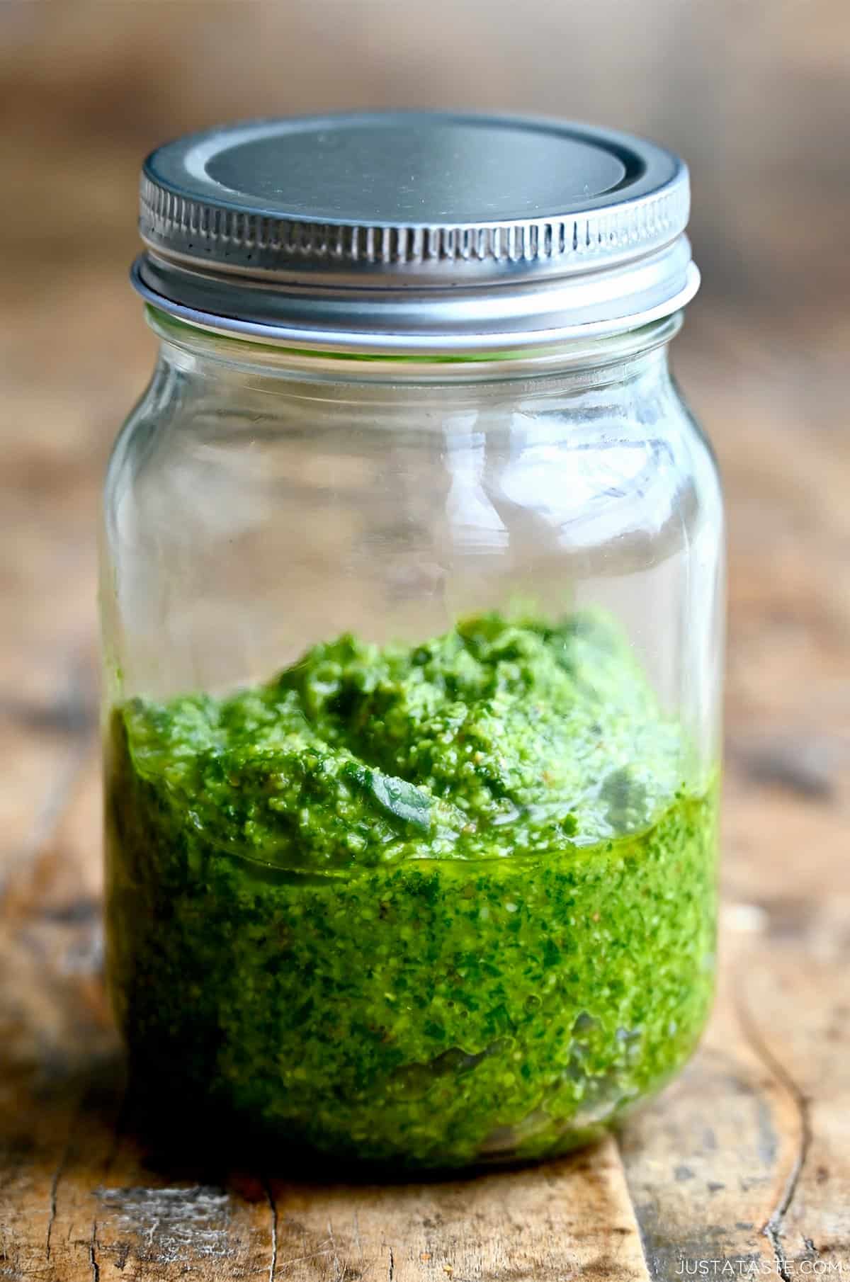 Homemade basil pesto in a mason jar.