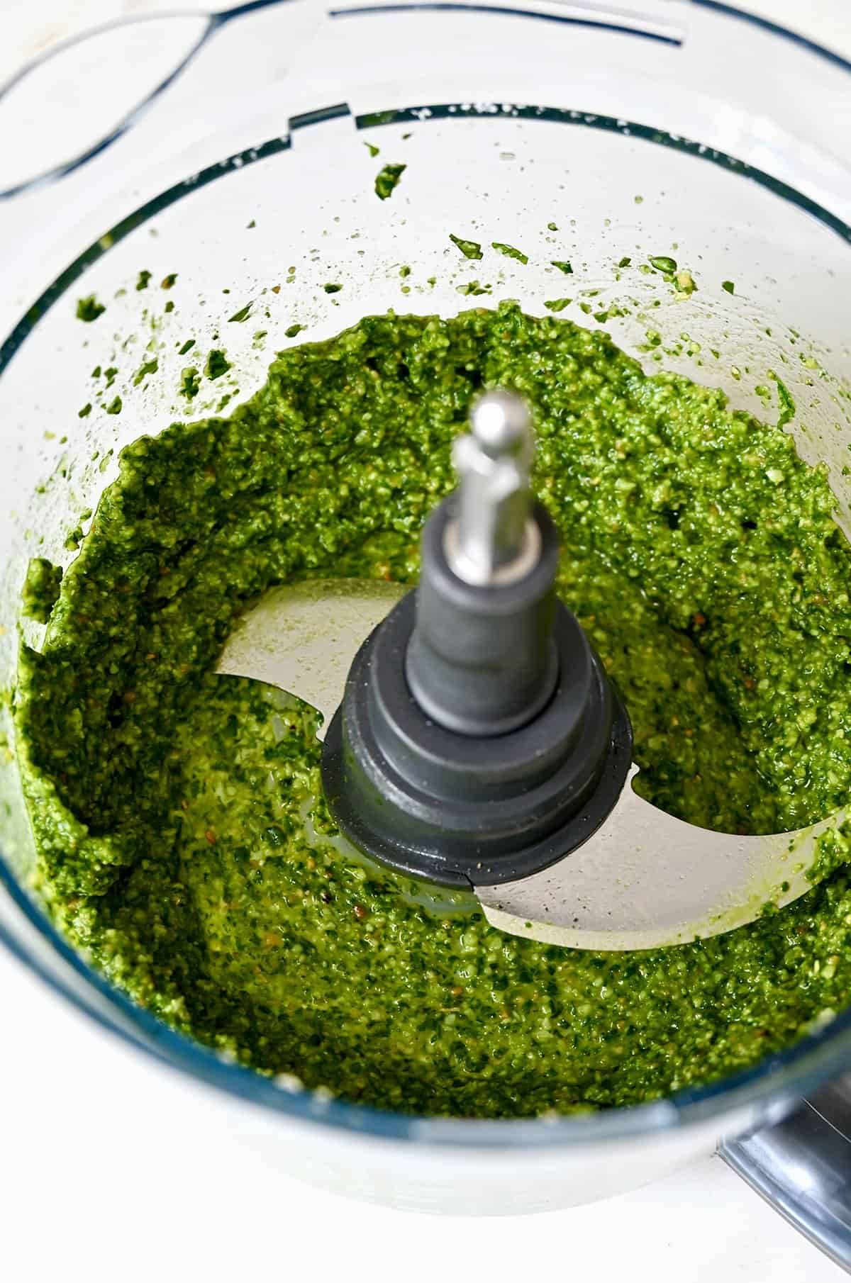 Blended pesto in a food processor.