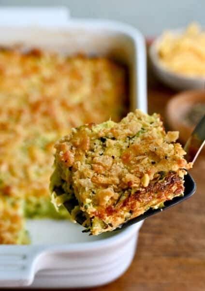 A slice of cheesy zucchini casserole on a spatula.