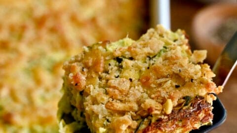 A slice of cheesy zucchini casserole on a spatula.