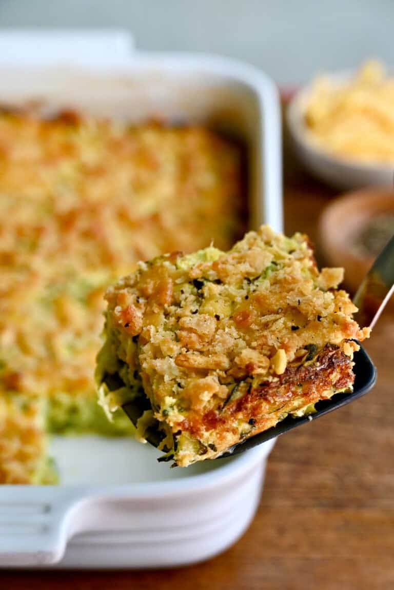 A slice of cheesy zucchini casserole on a spatula.