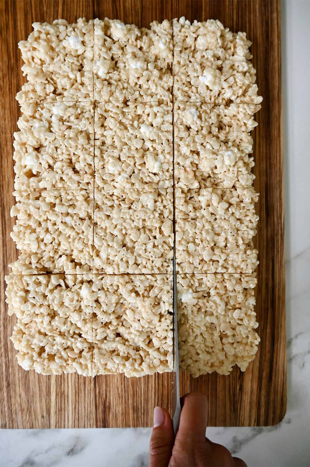 Slicing marshmallow treats into squares.