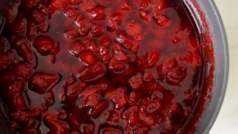 Homemade strawberry syrup in a saucepan.