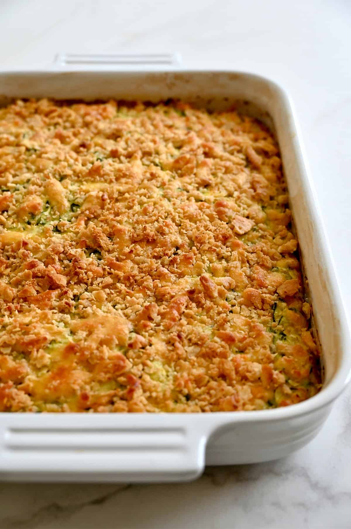 A zucchini casserole with a toasted cracker topping fresh out of the oven. 