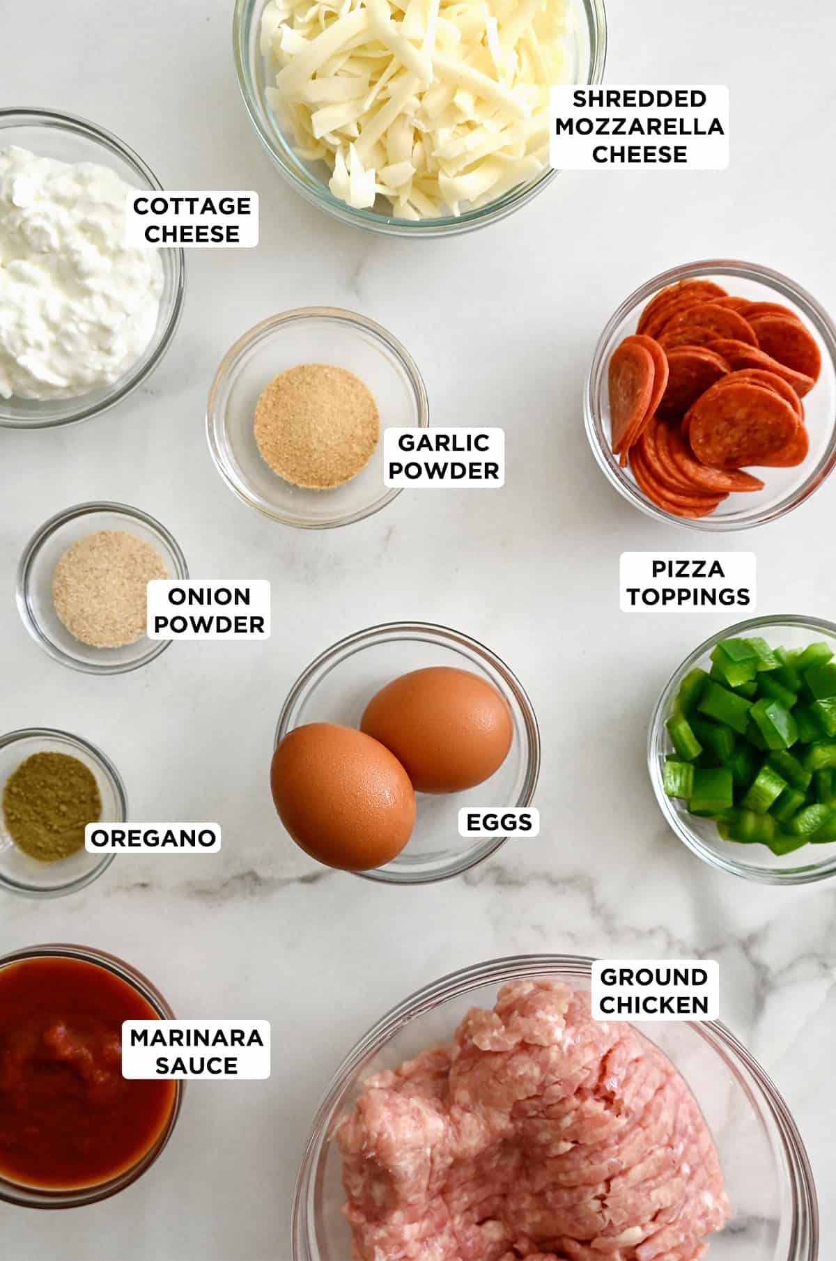 Ingredients to make a chicken pizza crust with pepperoni and diced green peppers in various sizes of glass bowls.