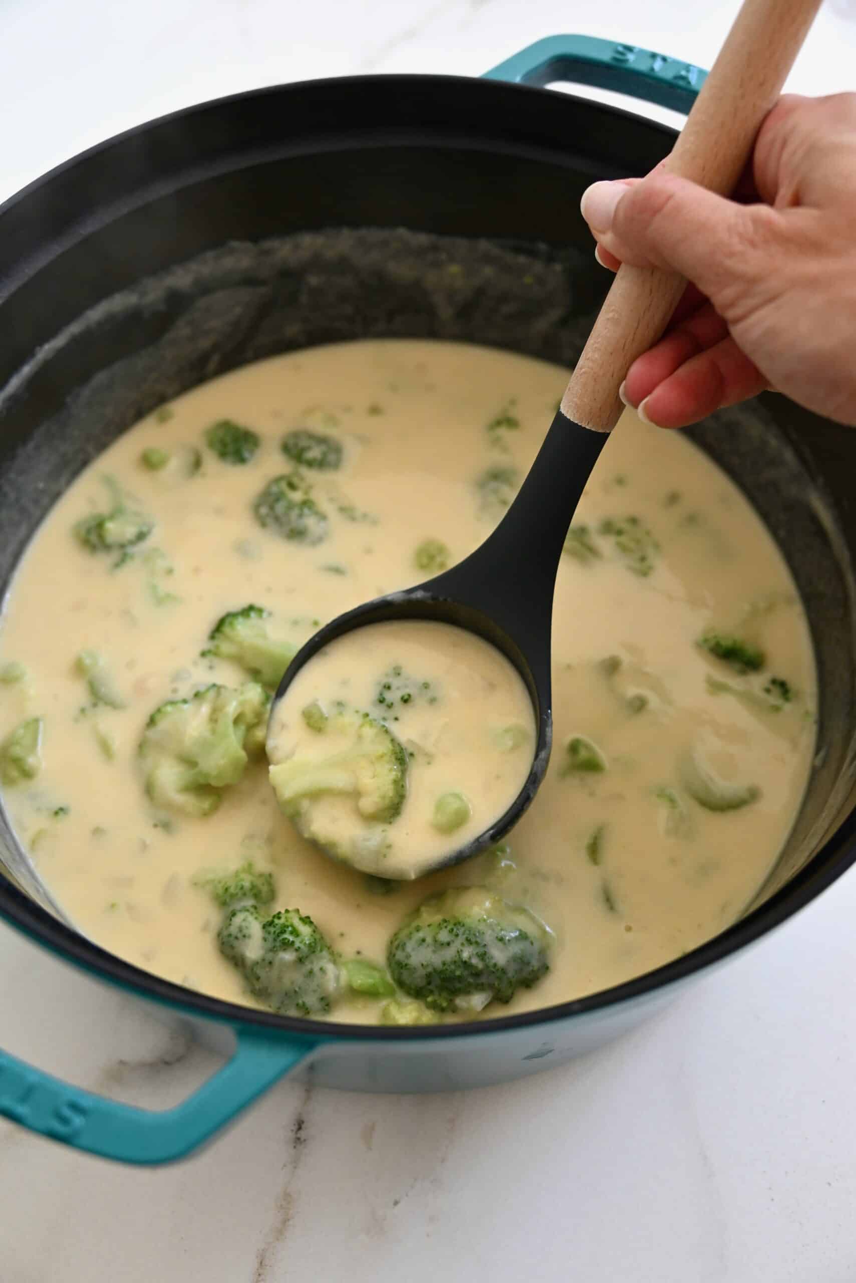 Cheddar cheese and broccoli soup in a stockpot before blending.