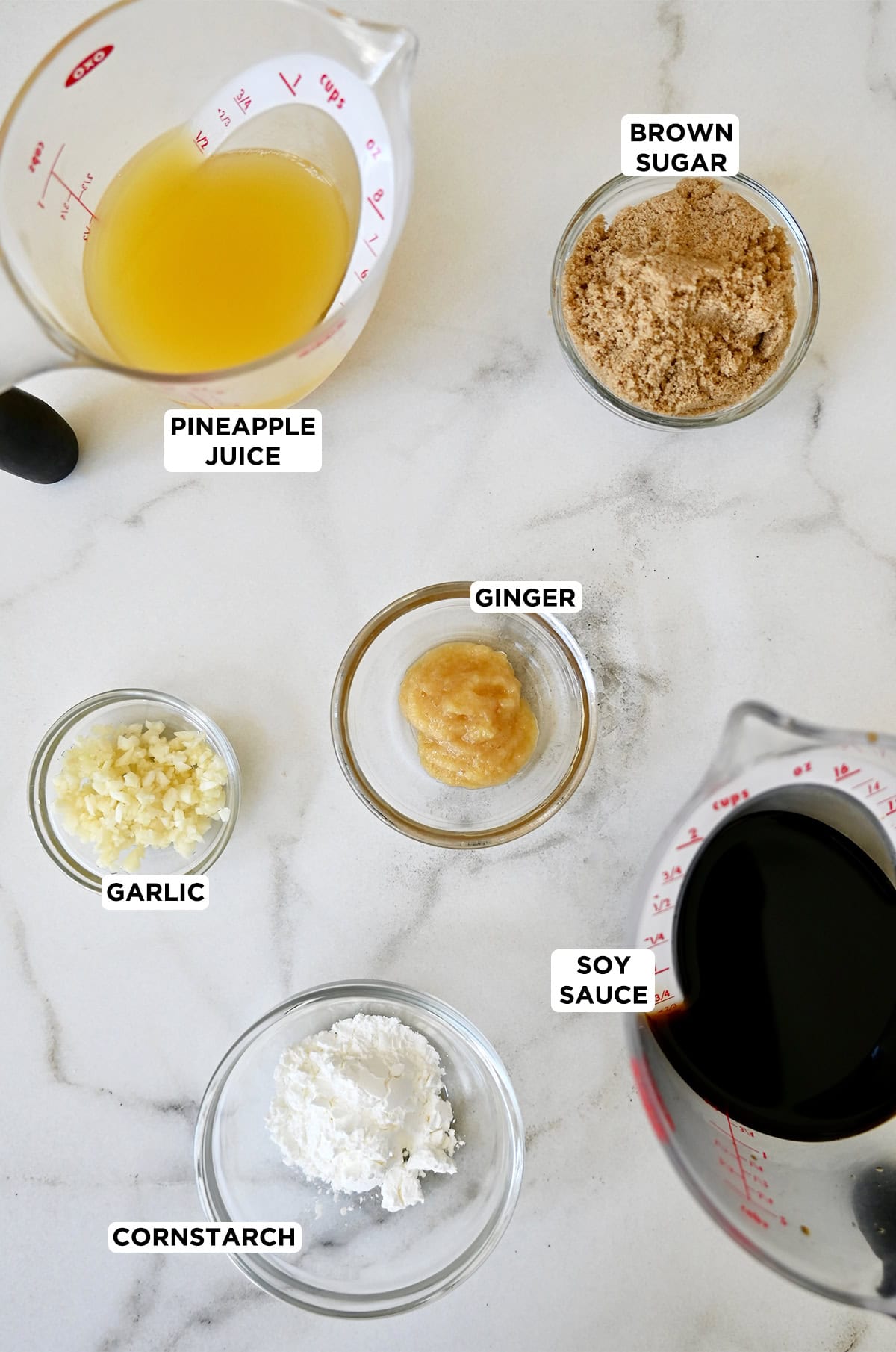 The six ingredients needed to make teriyaki sauce at home, including pineapple juice, low sodium soy sauce, brown sugar, minced garlic and ginger, and cornstarch.