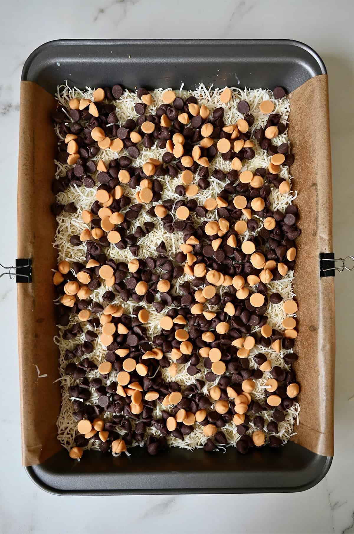 Adding a layer of butterscotch chips on top of chocolate chips and coconut for 7-layer bars.