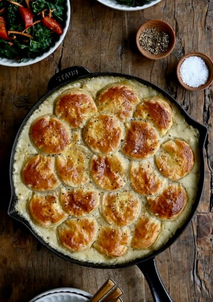 Easy homemade chicken pot pie topped with a puff pastry crust in a cast iron skillet.
