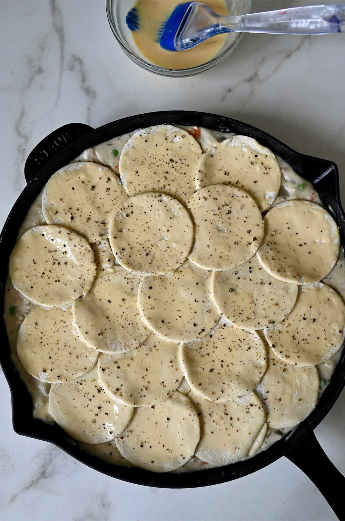 Puff pastry pot pie brushed with an egg wash before baking.