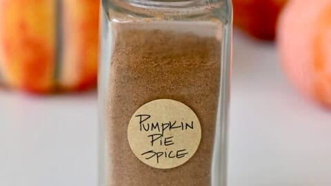 Homemade pumpkin pie spice in a spice jar with a handwritten label.
