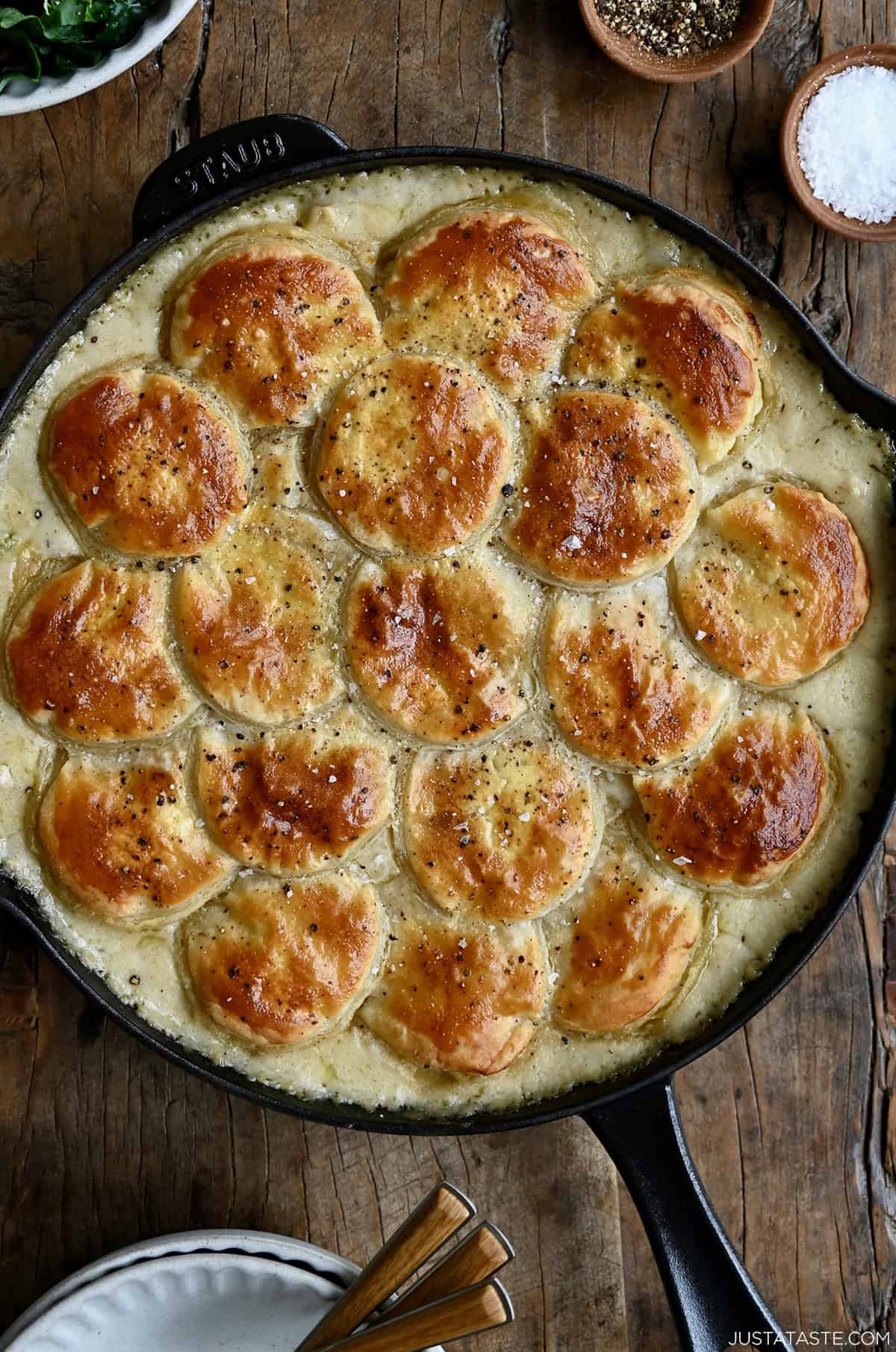 Chicken pot pie in a skillet topped with a golden, flaky puff pastry crust.